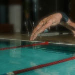 Schwimmer mit Sprung vom Beckenrand
