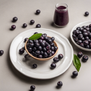 Açai berries on a plate, with açai berry juice in a glass